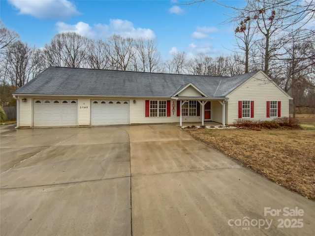 ranch-style home with concrete driveway and an attached garage