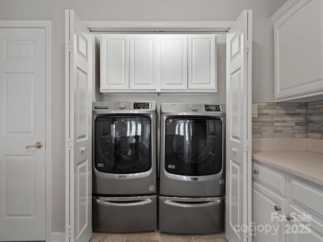 laundry area with cabinet space and washer and clothes dryer