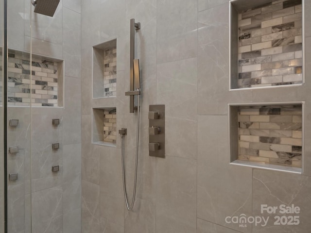 full bath with a tile shower