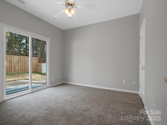 spare room featuring ceiling fan, carpet, visible vents, and baseboards