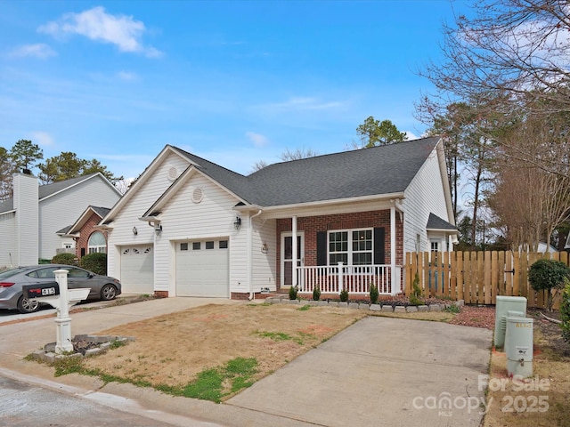 view of front of property with brick siding, a porch, fence, a garage, and driveway