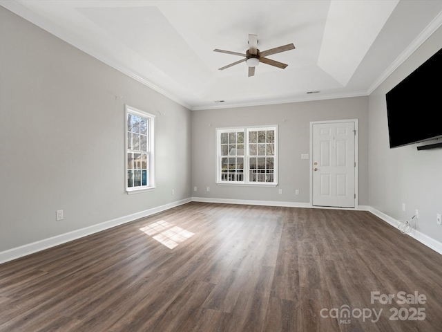 unfurnished living room featuring dark wood-type flooring, a raised ceiling, baseboards, and a ceiling fan