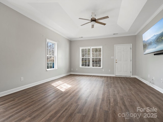 unfurnished living room featuring dark wood-style flooring, a raised ceiling, a ceiling fan, and baseboards