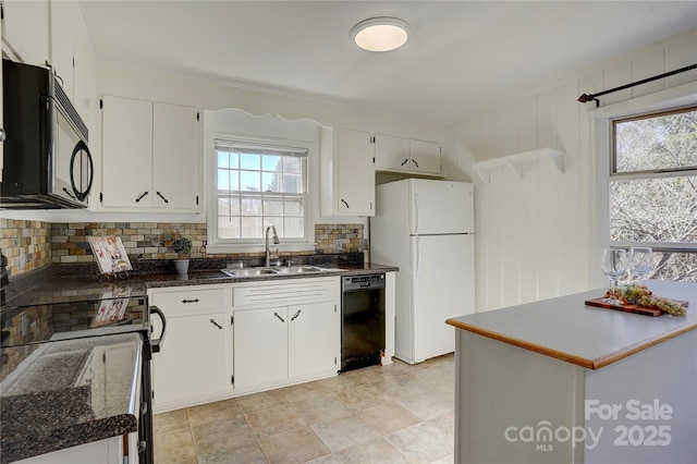 kitchen featuring a healthy amount of sunlight, black appliances, white cabinetry, and a sink