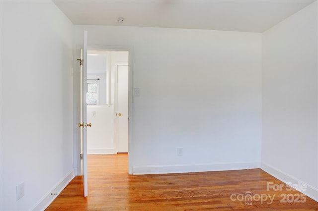 unfurnished room featuring light wood-style flooring and baseboards