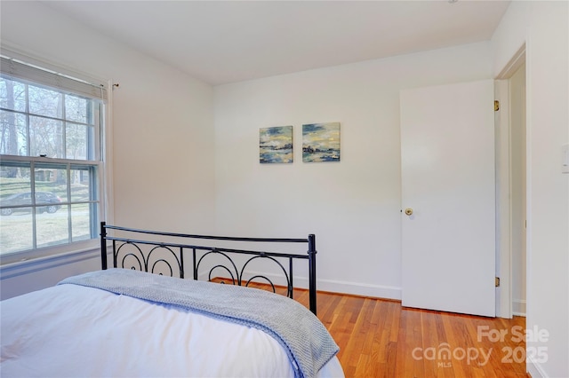 bedroom featuring light wood-type flooring and baseboards