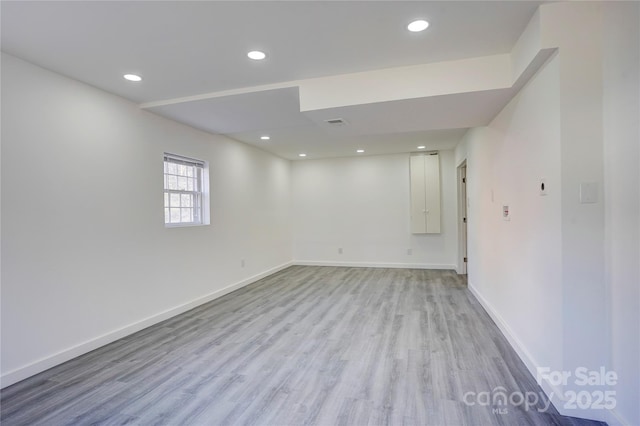 basement with light wood finished floors, baseboards, and recessed lighting