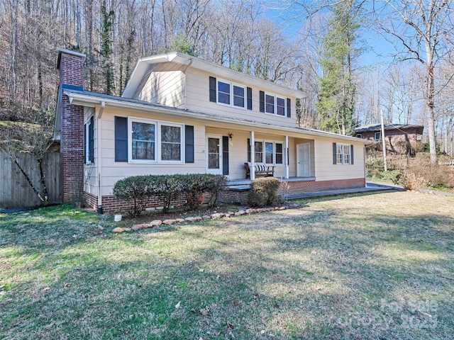 view of front of property with covered porch, a chimney, fence, and a front lawn