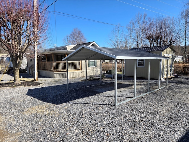 exterior space featuring a carport and gravel driveway