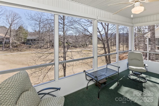 sunroom featuring ceiling fan