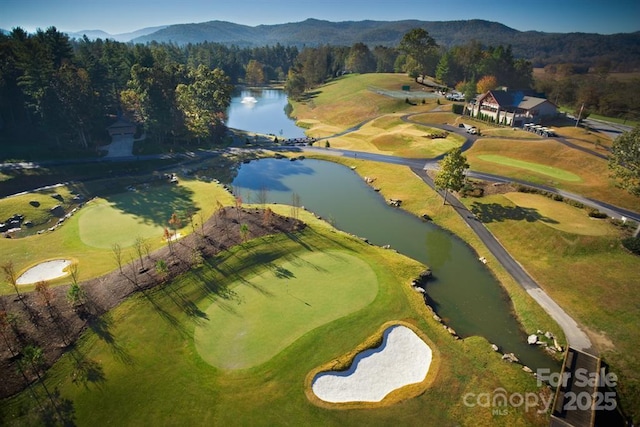 birds eye view of property featuring golf course view and a water and mountain view