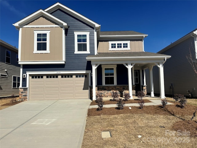 craftsman inspired home featuring a garage, stone siding, board and batten siding, and concrete driveway