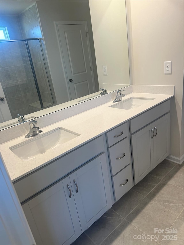 bathroom featuring double vanity, a shower stall, and a sink