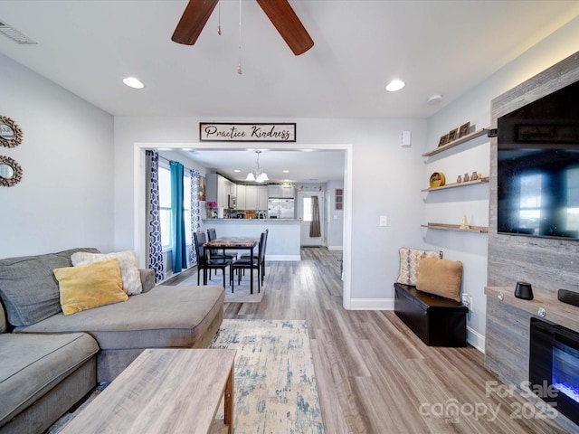 living area featuring ceiling fan, recessed lighting, visible vents, baseboards, and light wood finished floors