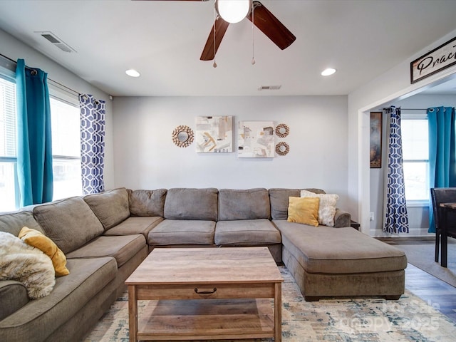 living area featuring light wood-style flooring, visible vents, and recessed lighting