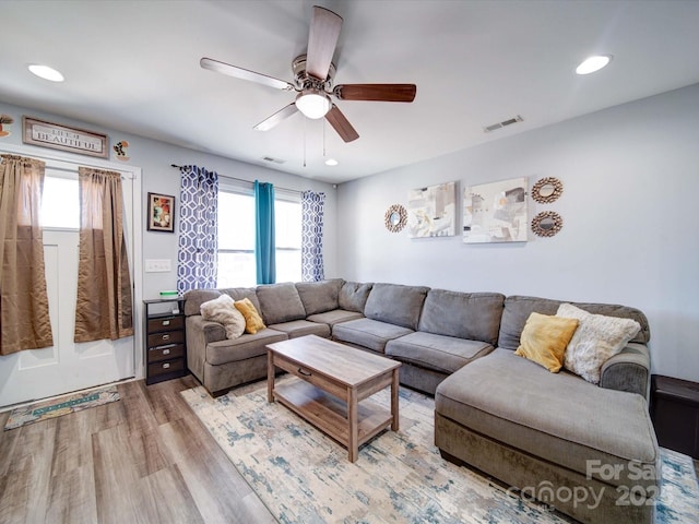 living room featuring recessed lighting, visible vents, and wood finished floors