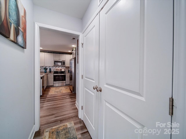 hall with wood finished floors