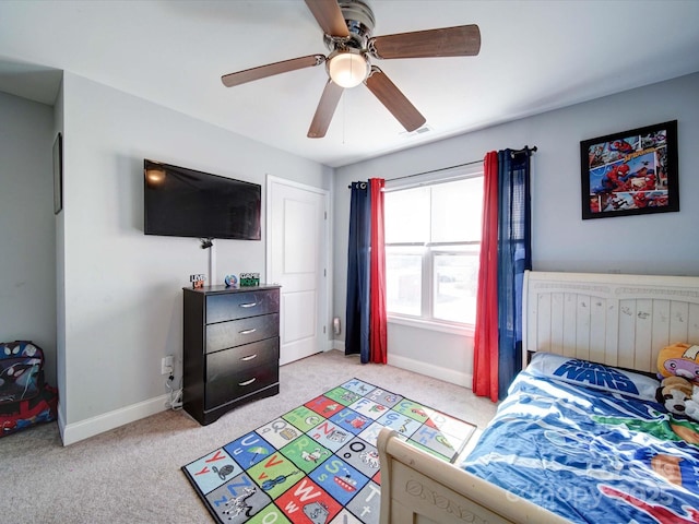 bedroom featuring visible vents, baseboards, ceiling fan, and light colored carpet