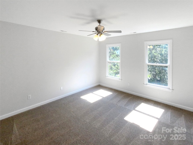 unfurnished room featuring carpet flooring, ceiling fan, and baseboards