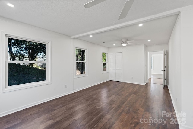 unfurnished room with dark wood-type flooring, recessed lighting, a textured ceiling, and baseboards