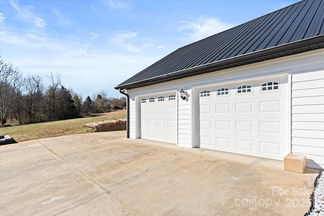 garage featuring concrete driveway