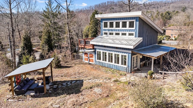 exterior space with metal roof and board and batten siding