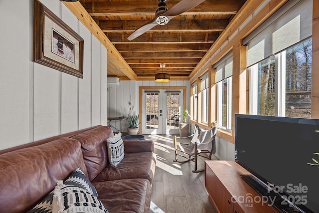 sunroom with wooden ceiling, a wall unit AC, a ceiling fan, french doors, and beamed ceiling