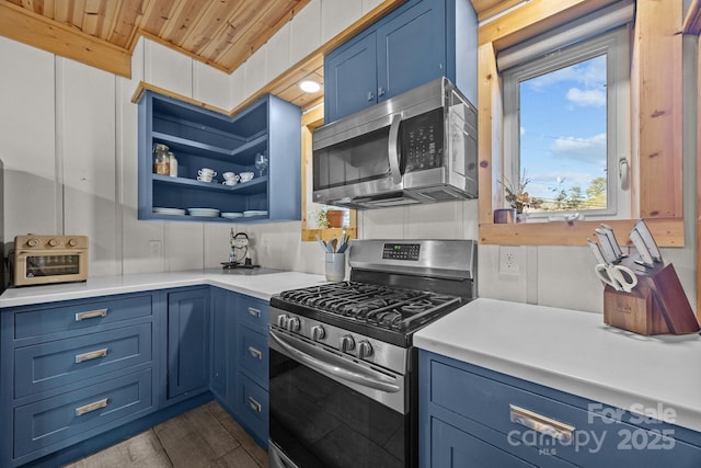 kitchen with stainless steel appliances, light countertops, and blue cabinetry