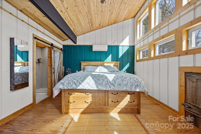 bedroom featuring light wood finished floors, a barn door, wooden ceiling, vaulted ceiling, and an AC wall unit