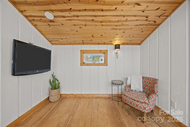 unfurnished room featuring lofted ceiling, wooden ceiling, and light wood finished floors