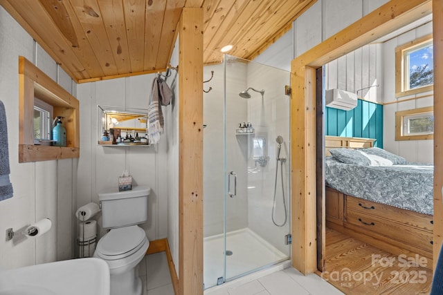 bathroom featuring toilet, wooden ceiling, connected bathroom, and a stall shower