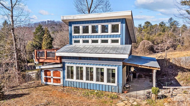 rear view of property featuring an outbuilding and board and batten siding