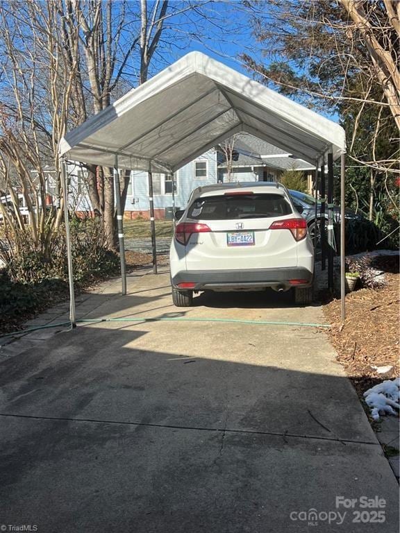 view of vehicle parking with a carport