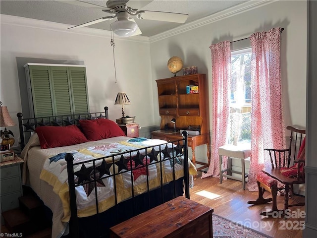 bedroom with ceiling fan, light wood-style flooring, and crown molding