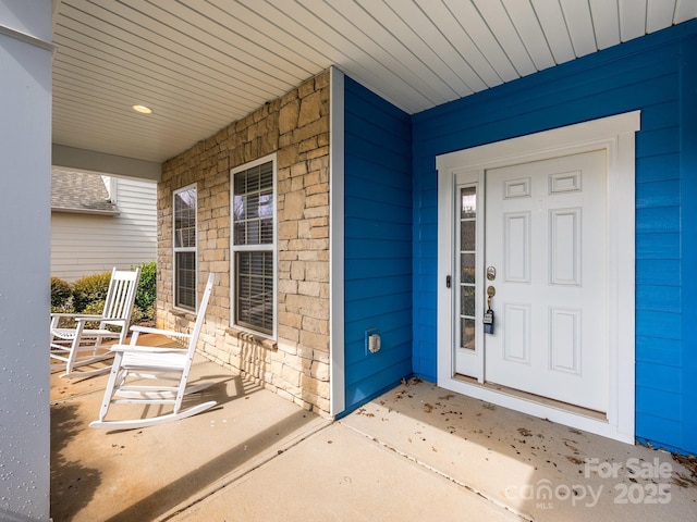 view of exterior entry featuring a porch