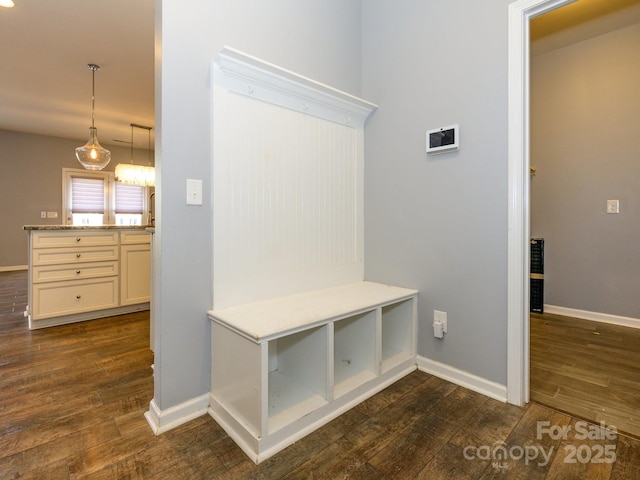 mudroom with baseboards and dark wood-style flooring