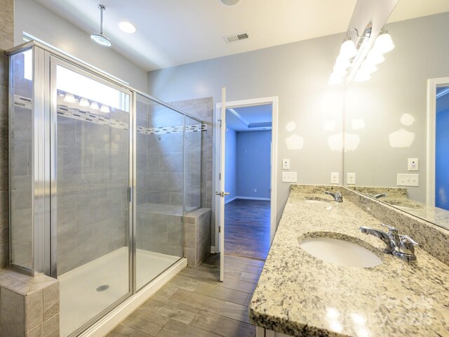 full bathroom with visible vents, a stall shower, and a sink