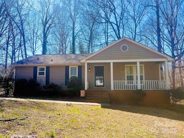 single story home featuring covered porch