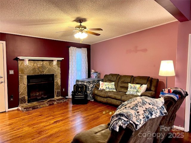 living room with a fireplace, wood finished floors, and crown molding