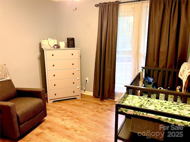 bedroom featuring light wood-style flooring