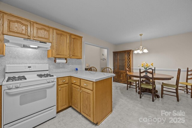 3039 Paraham Rd S, York, SC 29745 - kitchen with gas range gas stove, under cabinet range hood, a peninsula, a chandelier, and light countertops