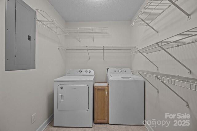 3039 Paraham Rd S, York, SC 29745 - laundry room featuring separate washer and dryer, cabinet space, electric panel, baseboards, and a textured ceiling