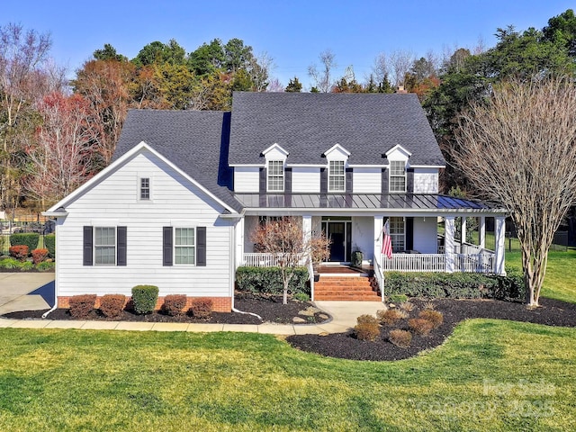 view of front of house featuring a shingled roof, a porch, metal roof, a standing seam roof, and a front lawn