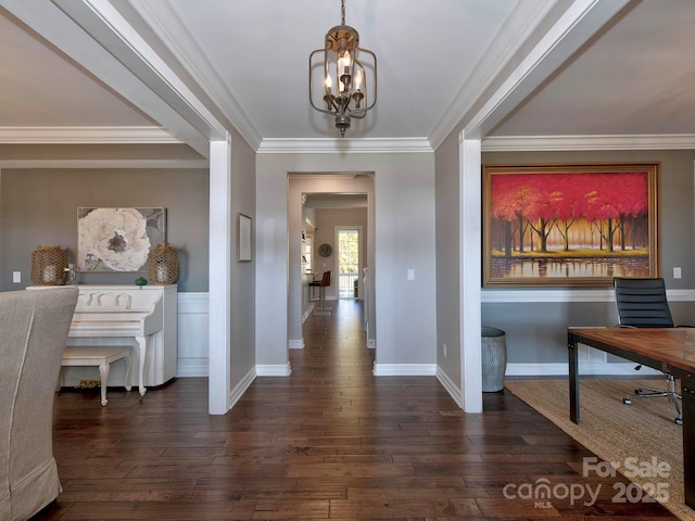 entrance foyer featuring crown molding, baseboards, dark wood finished floors, and a notable chandelier