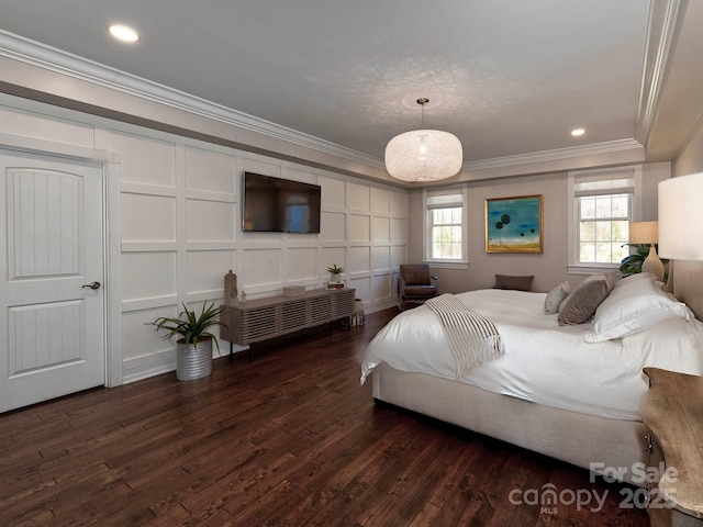 bedroom featuring dark wood-style floors, crown molding, recessed lighting, and a decorative wall