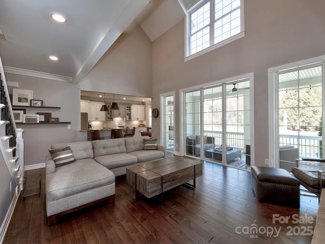 living area with recessed lighting, dark wood-type flooring, baseboards, ornamental molding, and stairway