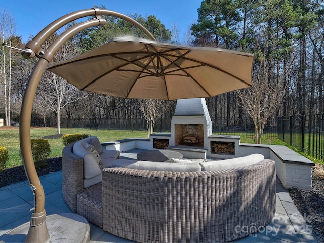 view of patio featuring an outdoor living space with a fireplace and fence