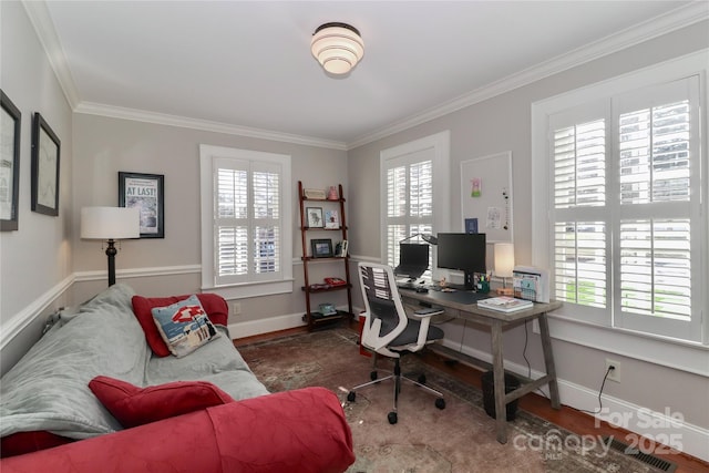 office space featuring a healthy amount of sunlight, crown molding, and wood finished floors