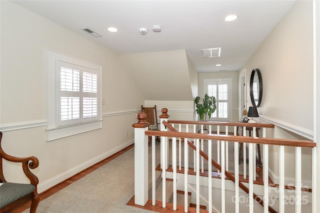 interior space featuring plenty of natural light, visible vents, and an upstairs landing