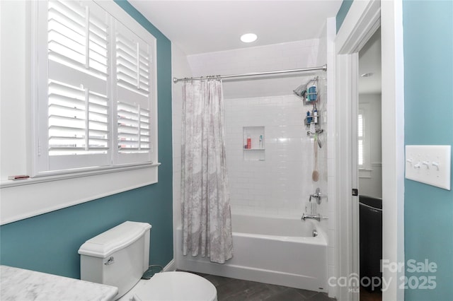 bathroom with toilet and shower / bath combo with shower curtain